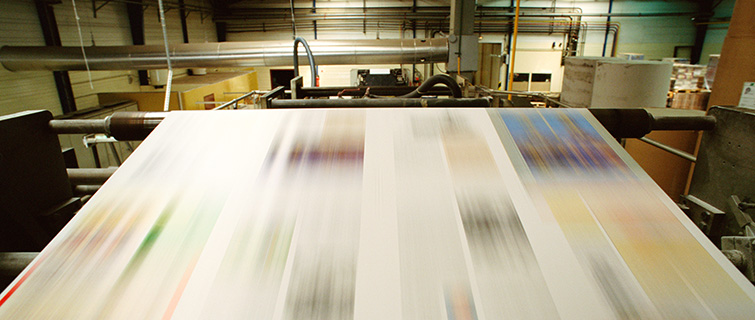 A printing press inside a newspaper production room