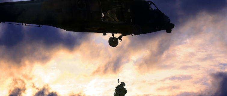 Military helo lifting soldier to safety