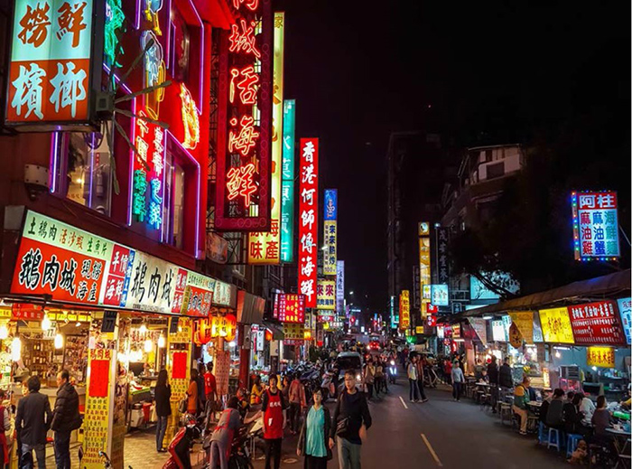 Wuhan street at night lined with neon signs